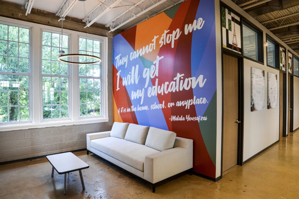 Image of colorful wall graphics with inspirational message behind a couch at Fannie C. Harris Youth Center.